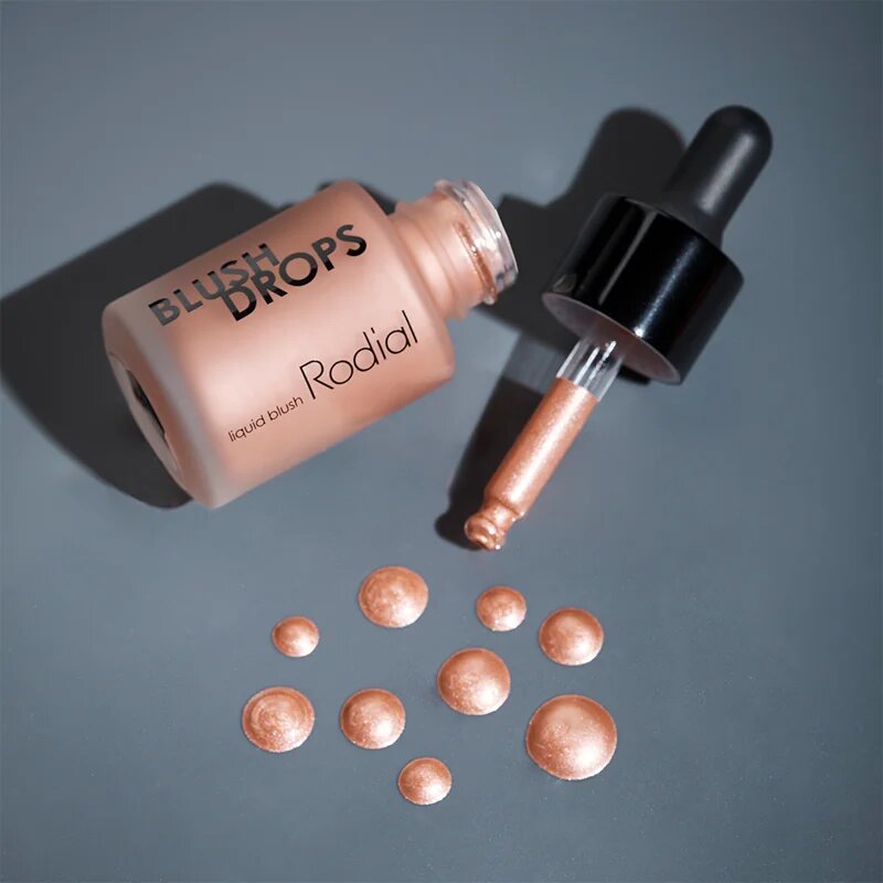 Rodial Blush Drops течен руж и блясък за устни придаващ хидратация и блясък цвят Sunset Kiss 15 мл.